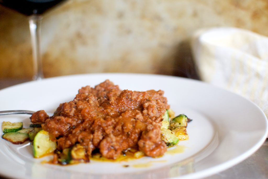 A keto dinner recipe idea! Easy spaghetti sauce served over parmesan zucchini!