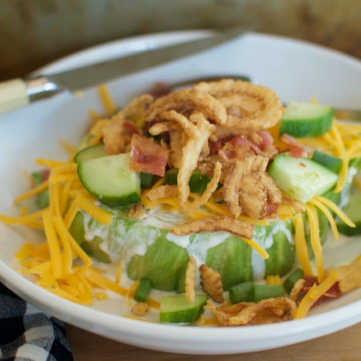 Easy wedge salad recipe with bacon, cheese, fried onions, and ranch dressing.