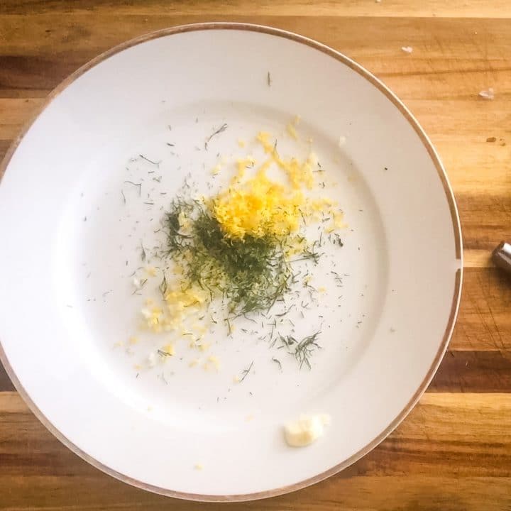 garlic, lemon, and dill on a plate