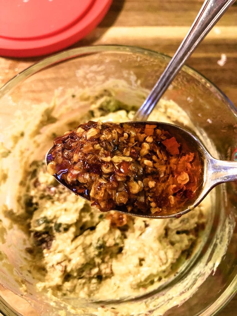 Adding Chili Onion Crunch to a Bowl of Italian Pimento Cheese