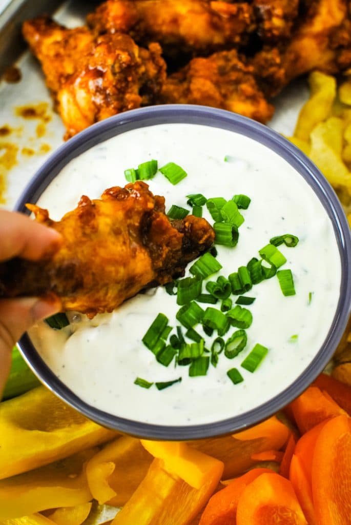 Dipping a Chicken Wing in Green Onion DIp