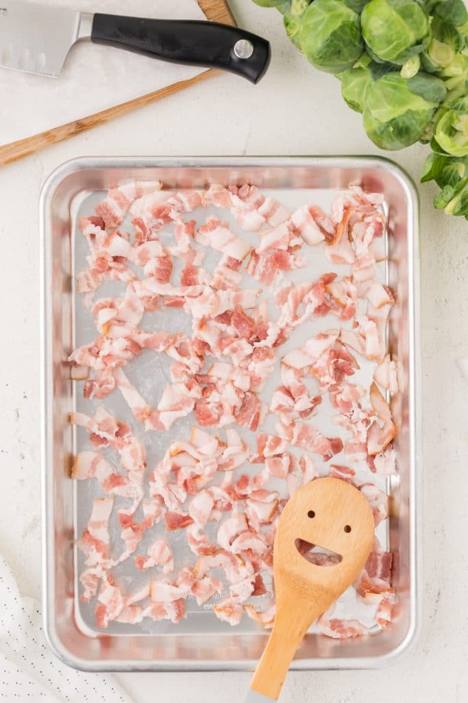 raw bacon on a sheet pan