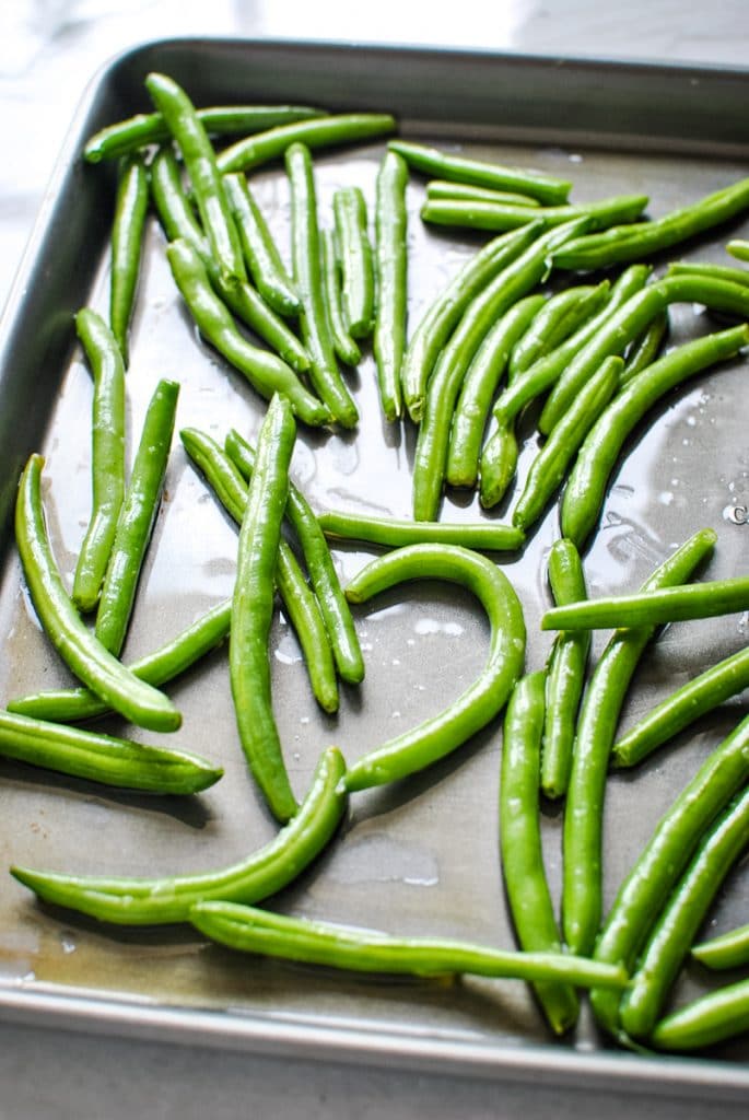 fresh green beans on a roasting pan