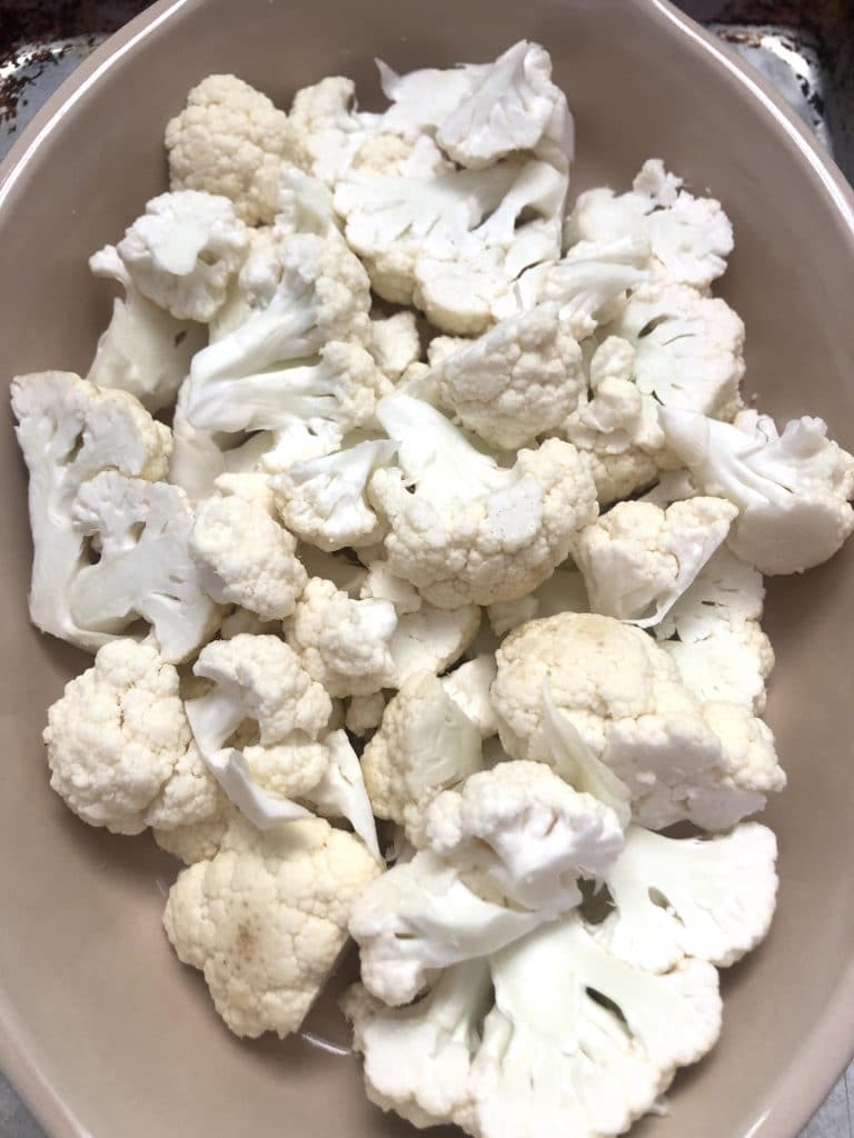 raw cauliflower in a baking dish