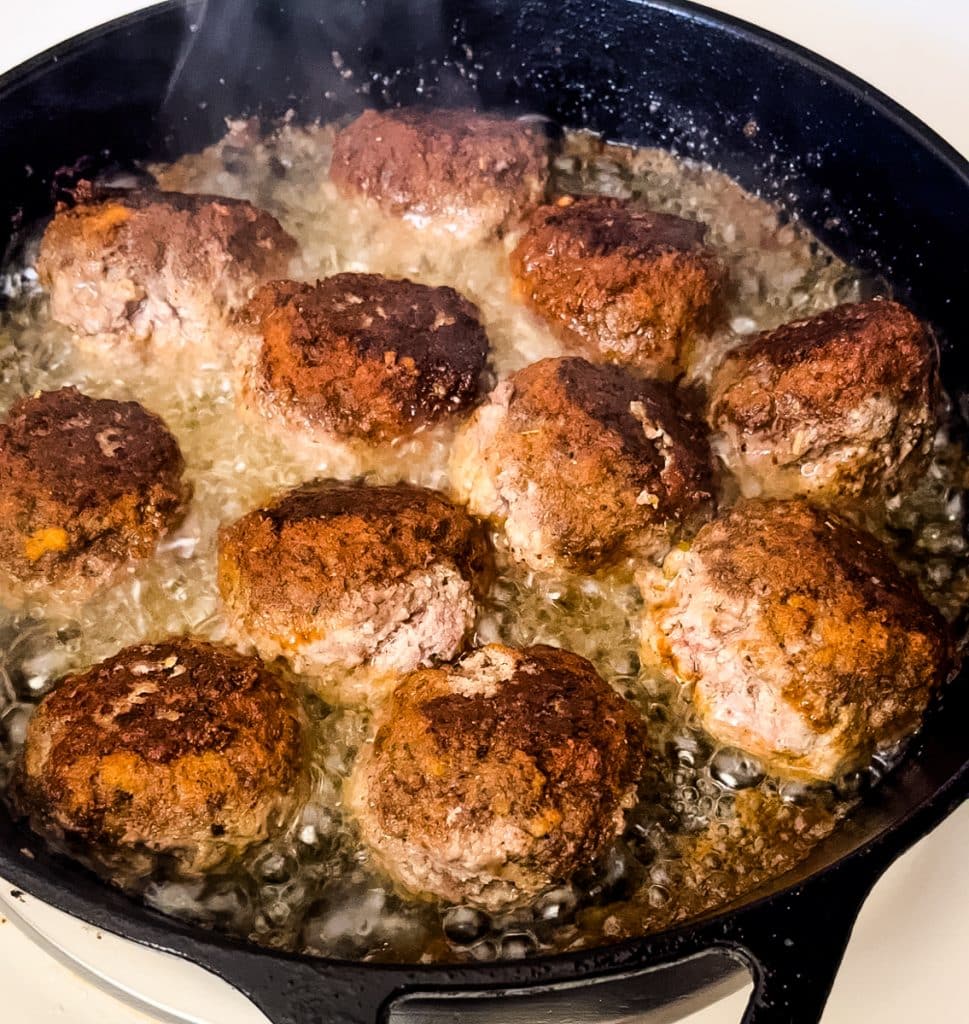 browned meatballs in a skillet