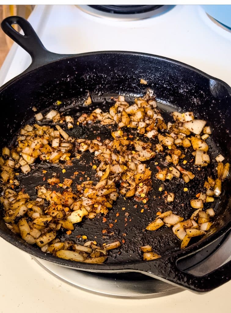 cooking onions in a skillet on the stove