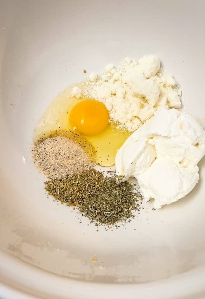 egg, ricotta cheese, and seasonings in a bowl