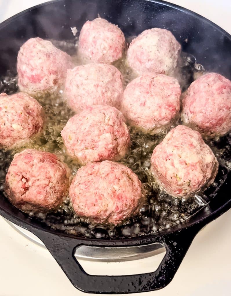 frying meatballs in a cast iron skillet