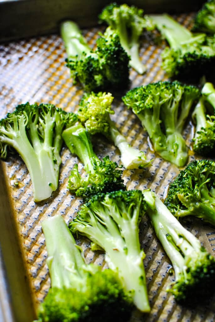 broccoli on a sheet pan, ready to be roasted