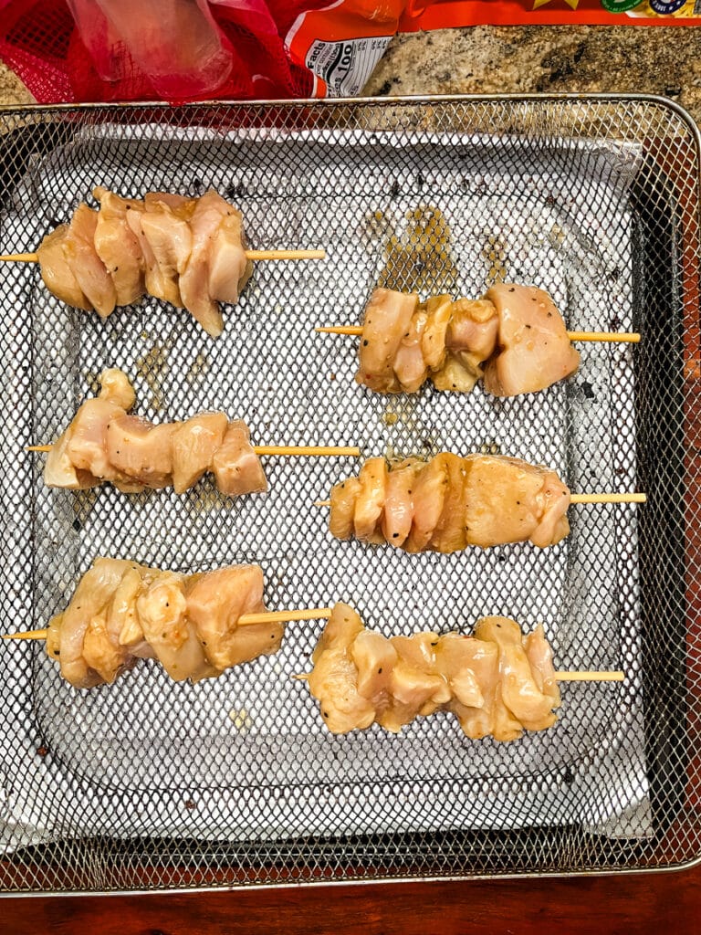 uncooked chicken in air fryer basket