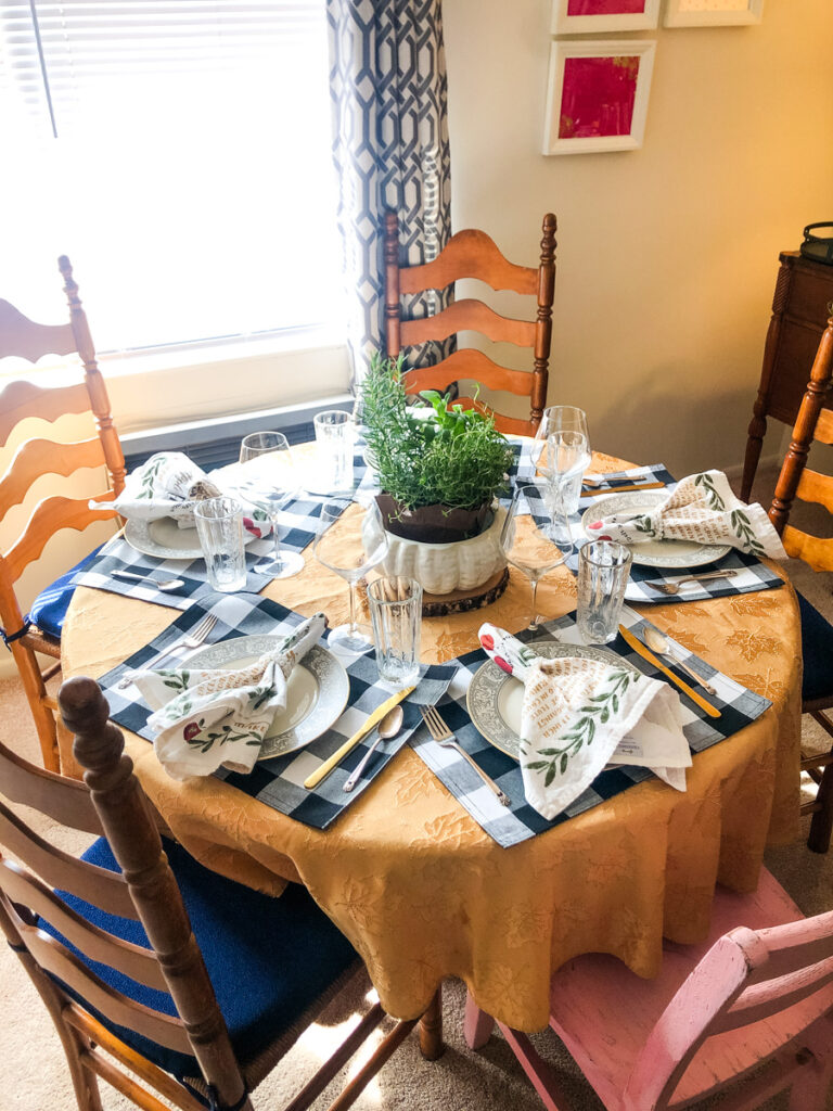 table setting for 4 people with a round table