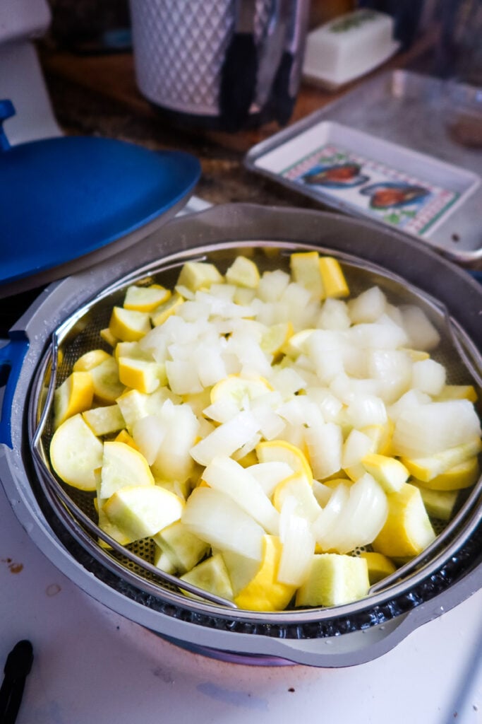 Sliced yellow squash and onions ready to steam for Sunshine Casserole