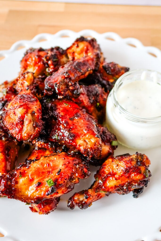 Air fryer chicken wings with honey butter glaze served on a white platter with ranch.