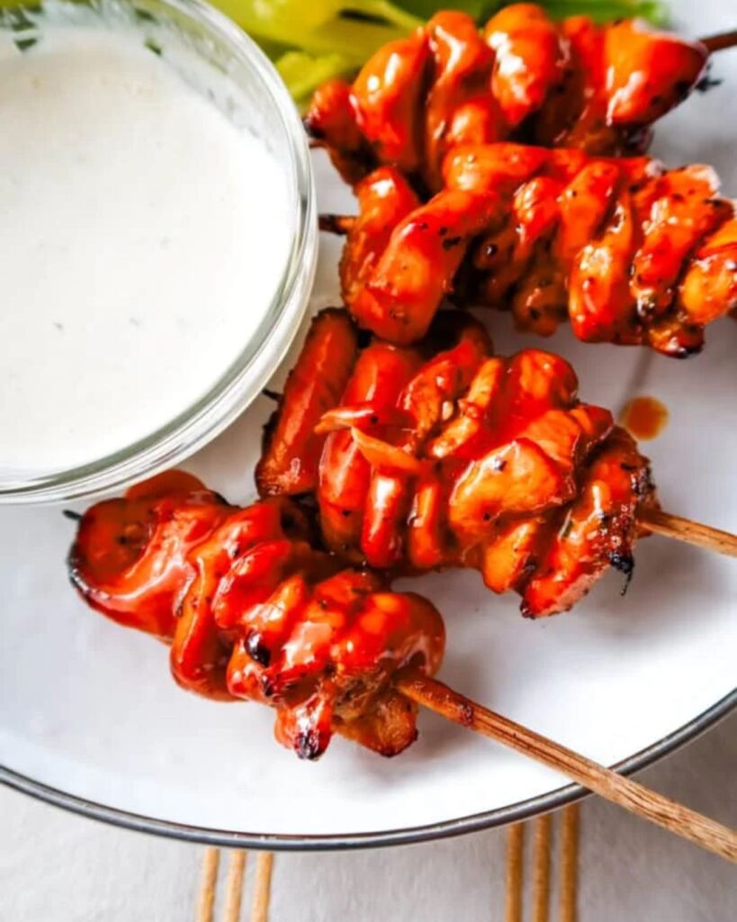 Hot honey buffalo chicken skewers on a platter for football watch parties