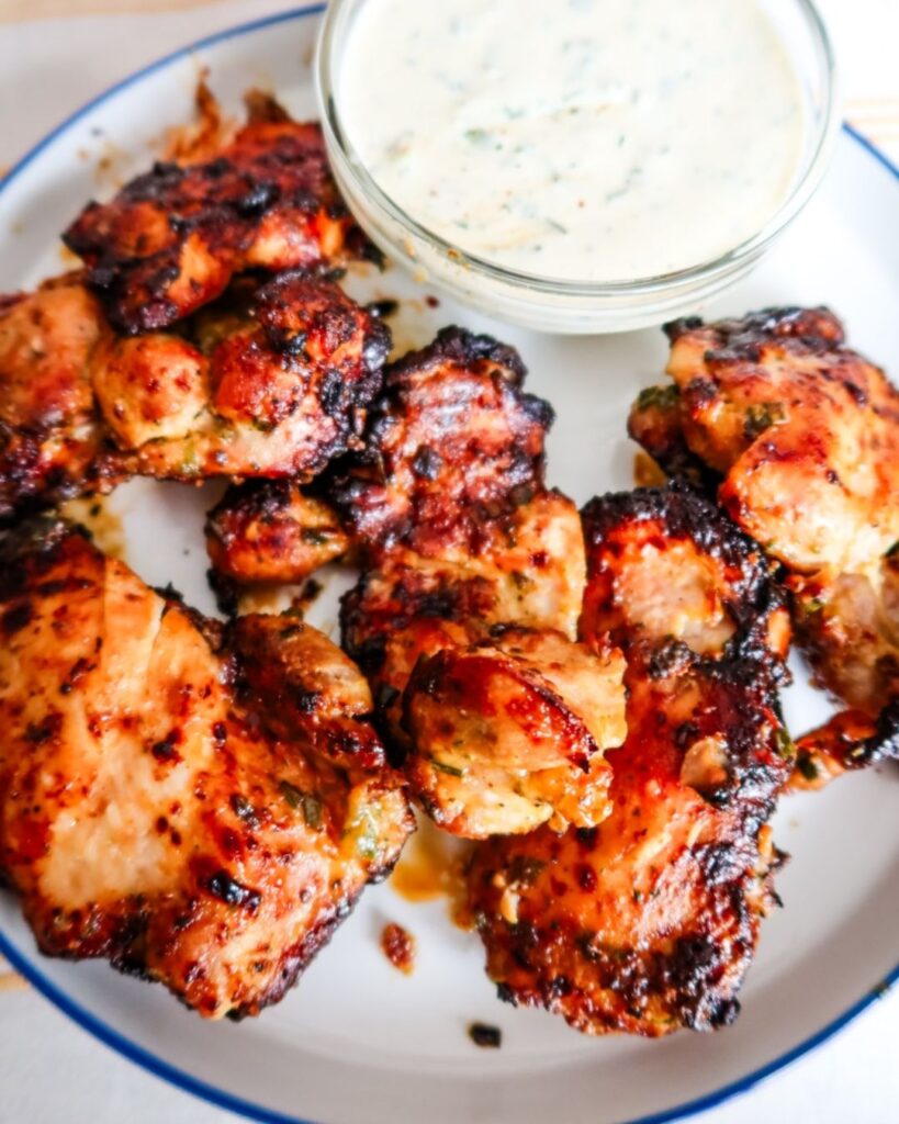 Juicy chicken thighs coated in hot honey ranch sauce for football food