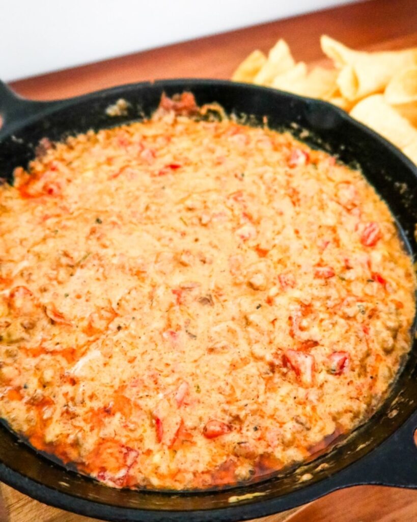 Creamy Rotel cheese dip served with tortilla chips, a football snack favorite.