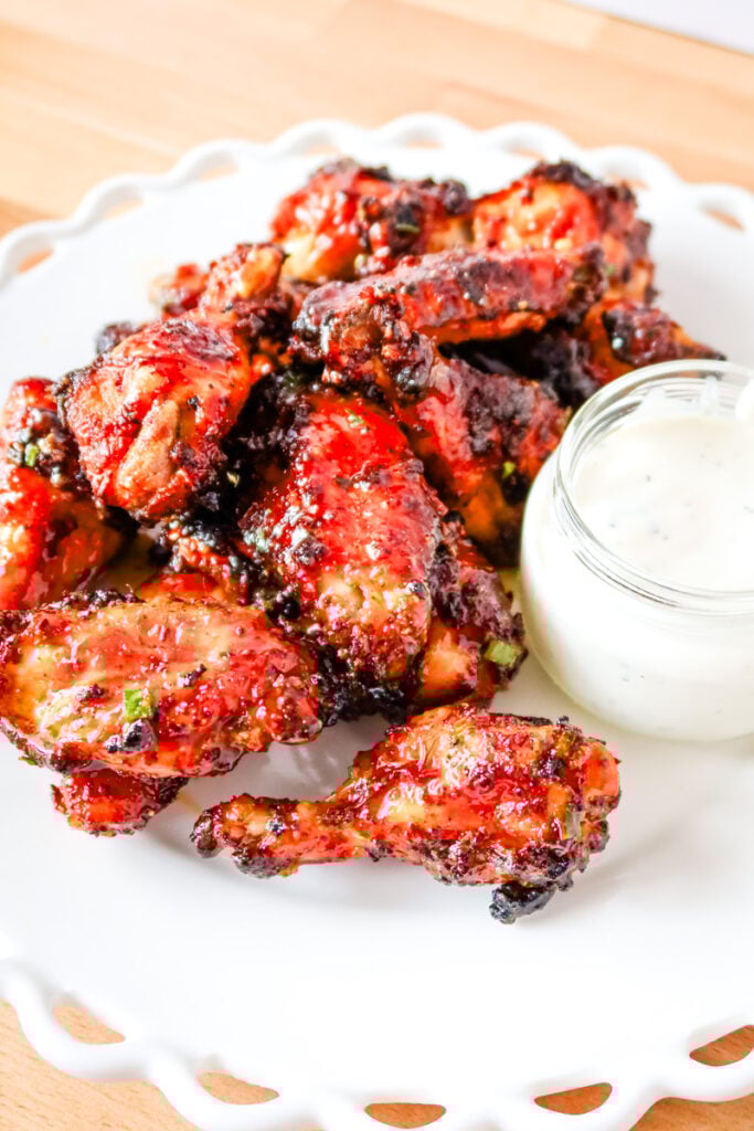 Overhead shot of crispy sweet and spicy chicken wings with a side of ranch.