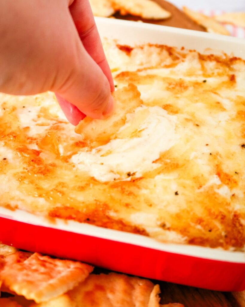Baking dish of Swiss onion dip with golden cheese top.