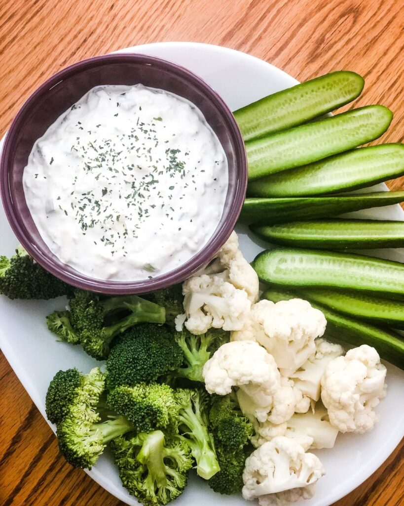 Bowl of cheddar dip with fresh vegetables
