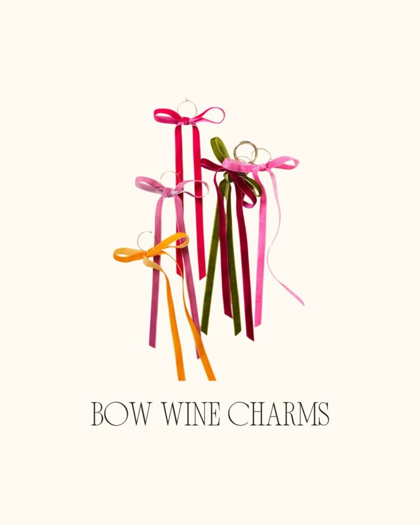Colorful velvet bow wine charms in pink, red, orange, and green, displayed on a neutral background.