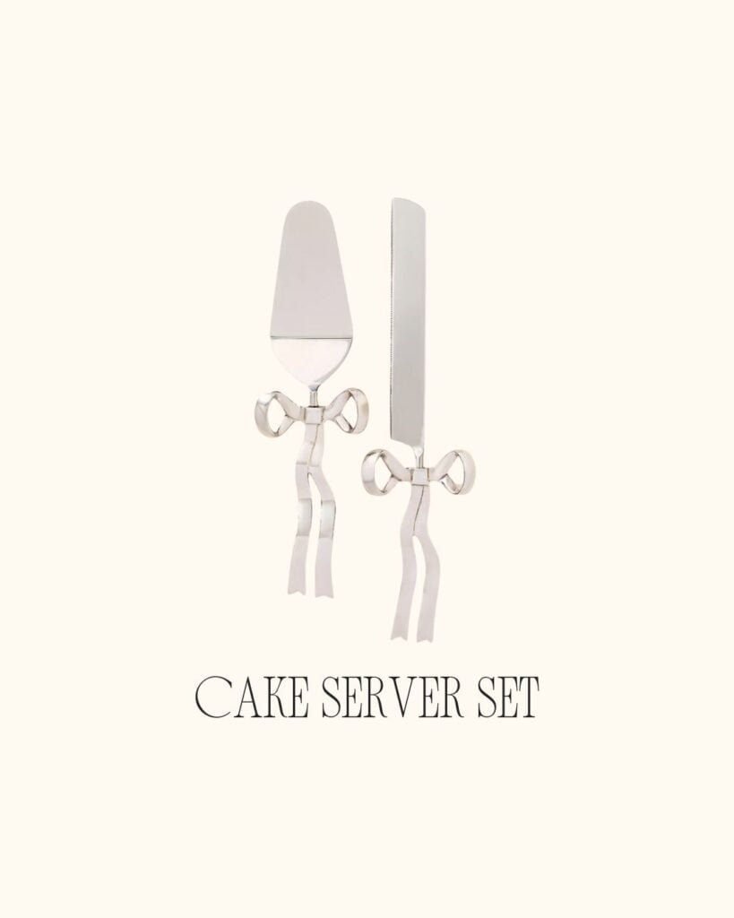 Silver cake server and knife set with delicate bow handles, displayed on a neutral background.