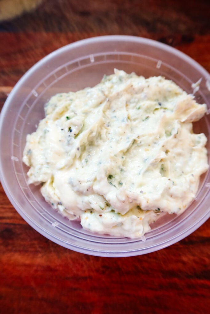 Close-up of creamy Thanksgiving Butternaise — a blend of butter, Duke’s mayonnaise, herbs, and Harlem Garlic Pepper — ready to spread on turkey or chicken.