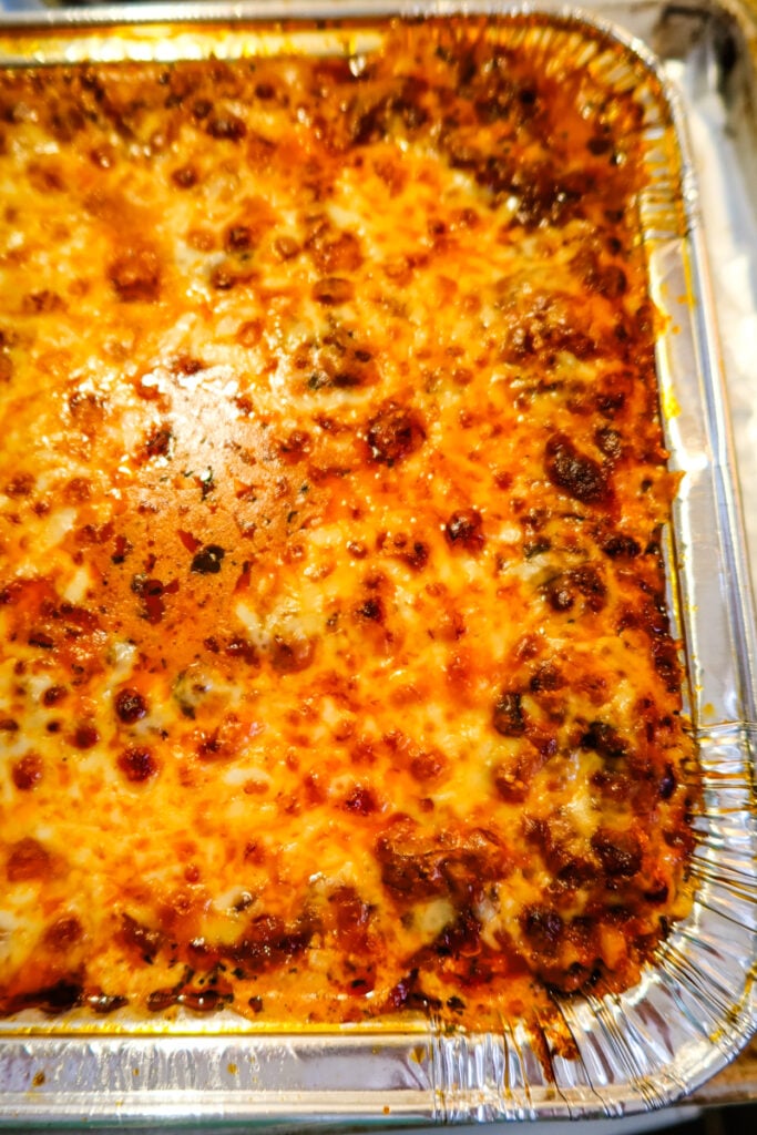 Sweetpea’s New Lasagna baked in a large foil pan with golden melted cheese