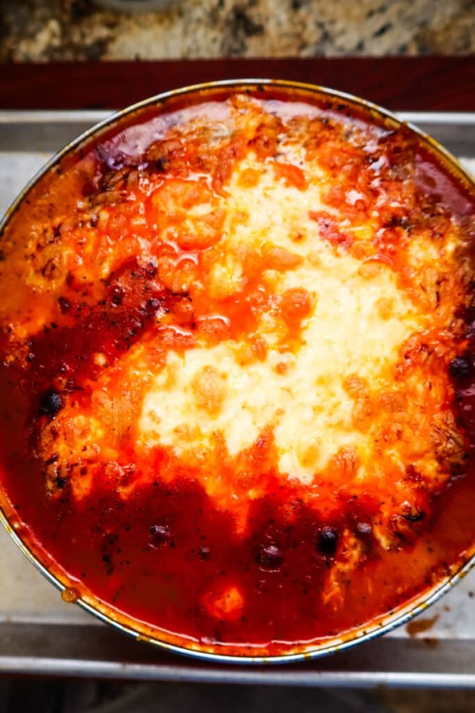 baked lasagna soup with melted ricotta and mozzarella on top.