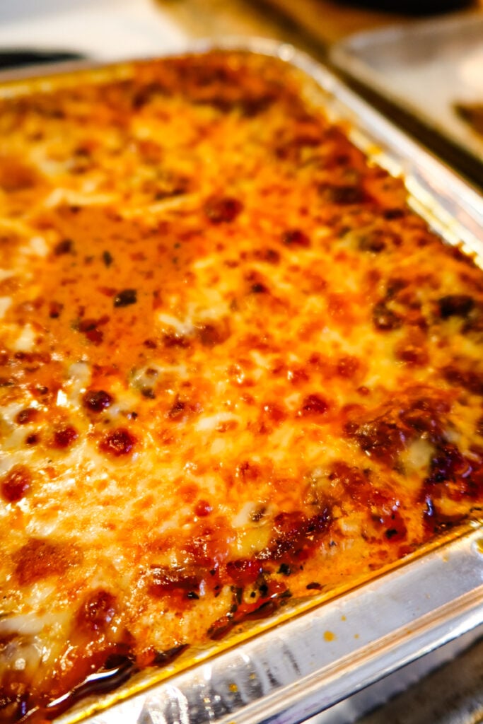 Close-up of Sweetpea’s New Lasagna with melted cheese and bubbling tomato sauce