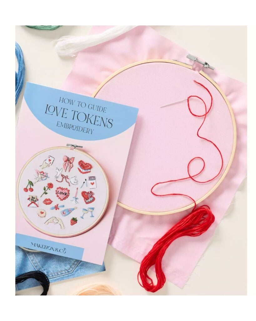 DIY beaded Apple Watch band kit with colorful beads arranged on a neutral surface