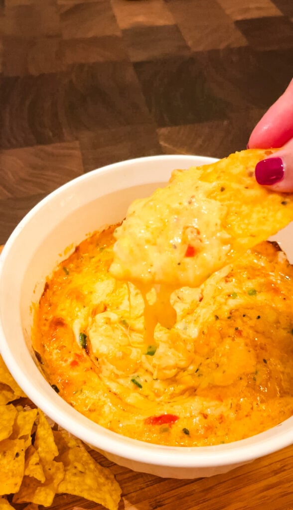 cheese pull from sweetpea's baked pimento cheese dip with tortilla chip